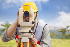 land surveyor conducting research using surveying equipment