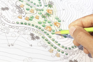 person sketching a detailed site plan