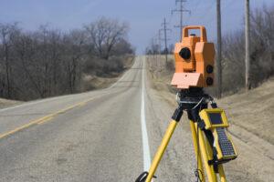land surveying equipment scoping edge of property