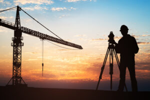 silhouette of surveyor at construction site