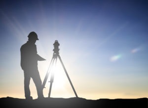 An engineer uses professional surveying equipment.
