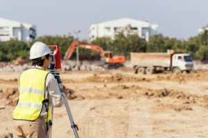 a land surveyor at a construction site