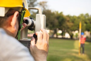 surveyor views marker on client’s property