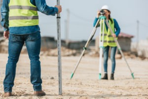 two land surveyors taking measurements